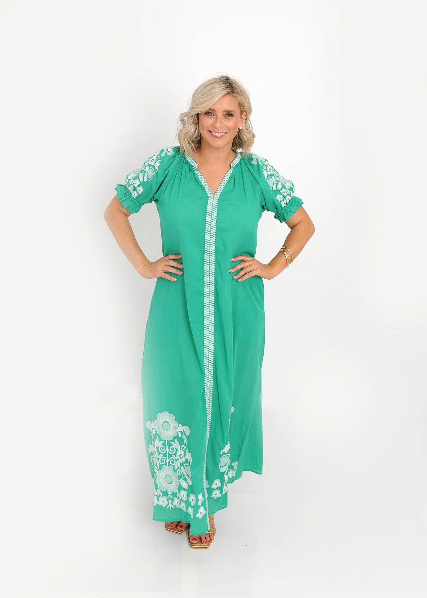 Emerald green embroidered midi dress with V-neckline and puff sleeves