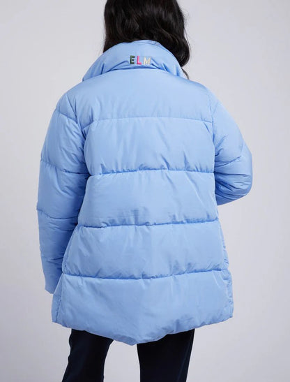 back of Women wearing puffer jacket in light blue
