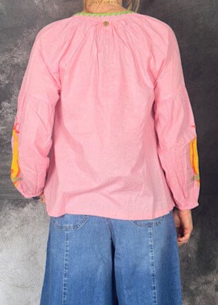 Person wearing a pink long-sleeve top 